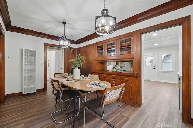 8680 Evergreen Ave, South Gate, CA 90280 - dining area with a heating unit, a chandelier, ornamental molding, and wood finished floors
