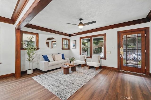 8680 Evergreen Ave, South Gate, CA 90280 - living area with wood finished floors, ornamental molding, a ceiling fan, and a textured ceiling