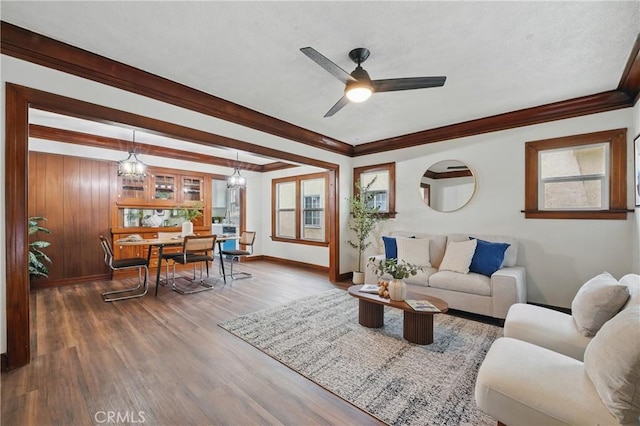 8680 Evergreen Ave, South Gate, CA 90280 - living area featuring a ceiling fan, wood finished floors, ornamental molding, and a chandelier