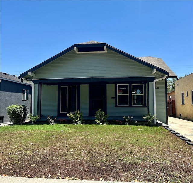 8680 Evergreen Ave, South Gate, CA 90280 - bungalow-style home with a porch and a front lawn