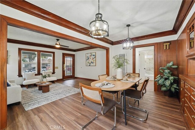 8680 Evergreen Ave, South Gate, CA 90280 - dining area with a chandelier, dark wood-style floors, and ornamental molding