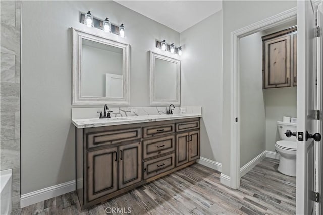 21813 Valley Vista Dr, Tehachapi, CA 93561 - bathroom with double vanity, wood finished floors, and a tub to relax in