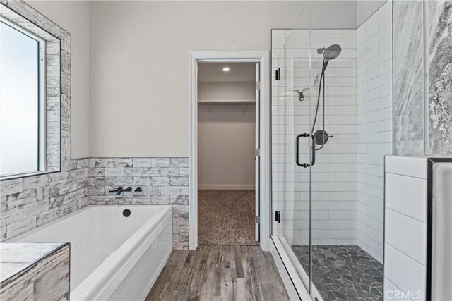 21813 Valley Vista Dr, Tehachapi, CA 93561 - bathroom featuring a stall shower, a jetted tub, a spacious closet, wood finished floors, and recessed lighting