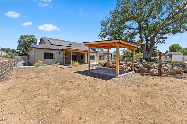 21813 Valley Vista Dr, Tehachapi, CA 93561 - rear view of property with a patio, solar panels, a gate, a fenced backyard, and stucco siding