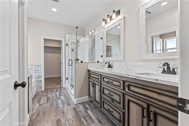 21813 Valley Vista Dr, Tehachapi, CA 93561 - full bathroom with a shower stall, double vanity, wood finished floors, and a walk in closet