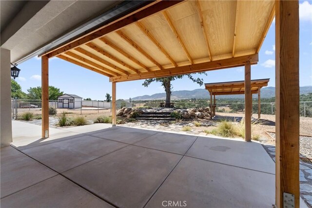 21813 Valley Vista Dr, Tehachapi, CA 93561 - fenced backyard featuring a mountain view, a patio, and an outbuilding