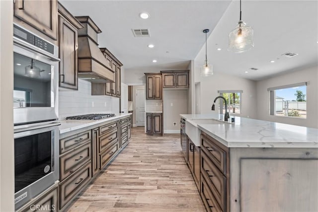 21813 Valley Vista Dr, Tehachapi, CA 93561 - kitchen featuring stainless steel appliances, light wood-type flooring, backsplash, recessed lighting, and custom range hood