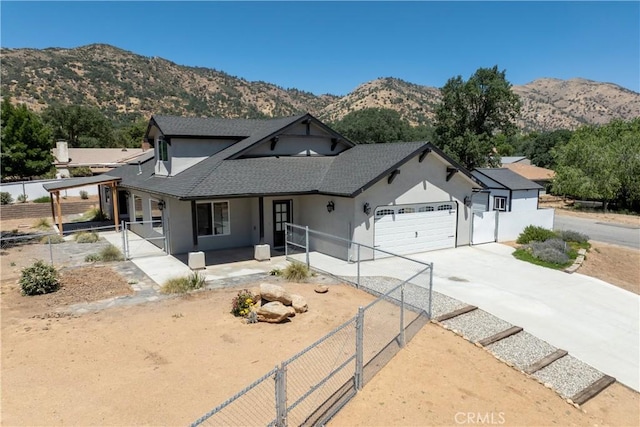 21813 Valley Vista Dr, Tehachapi, CA 93561 - view of front of house with a gate, stucco siding, an attached garage, driveway, and roof with shingles