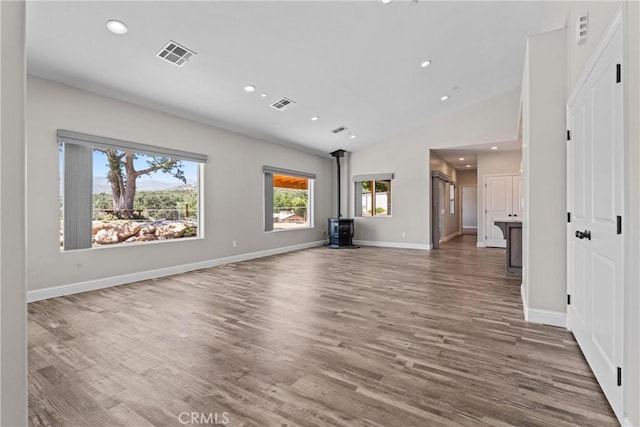 21813 Valley Vista Dr, Tehachapi, CA 93561 - unfurnished living room featuring a wood stove, wood finished floors, vaulted ceiling, and recessed lighting