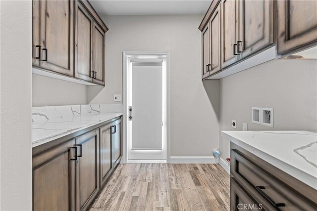 21813 Valley Vista Dr, Tehachapi, CA 93561 - washroom featuring cabinet space, light wood finished floors, hookup for an electric dryer, and hookup for a washing machine