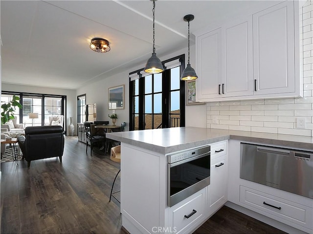 229 Marine Pl, Manhattan Beach, CA 90266 - kitchen with stainless steel microwave, open floor plan, a warming drawer, white cabinetry, and a peninsula
