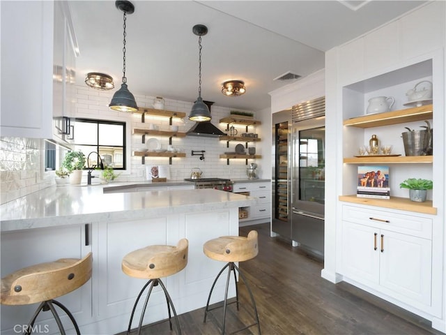229 Marine Pl, Manhattan Beach, CA 90266 - kitchen with open shelves, tasteful backsplash, white cabinetry, a kitchen breakfast bar, and light stone countertops