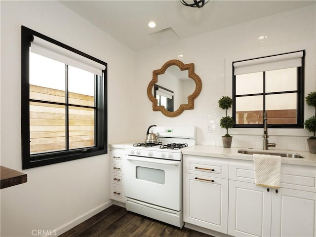 229 Marine Pl, Manhattan Beach, CA 90266 - kitchen with white gas range oven, dark wood-style floors, white cabinetry, and light countertops