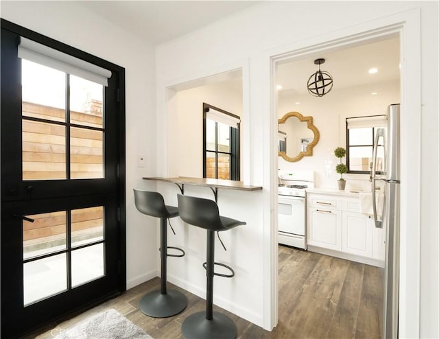 229 Marine Pl, Manhattan Beach, CA 90266 - kitchen featuring gas range gas stove, freestanding refrigerator, wood finished floors, and white cabinets
