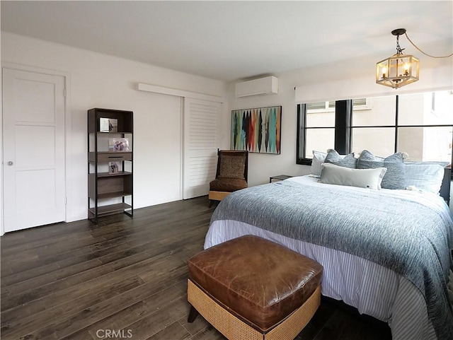 229 Marine Pl, Manhattan Beach, CA 90266 - bedroom with a wall mounted air conditioner, multiple windows, a chandelier, and dark wood-style floors