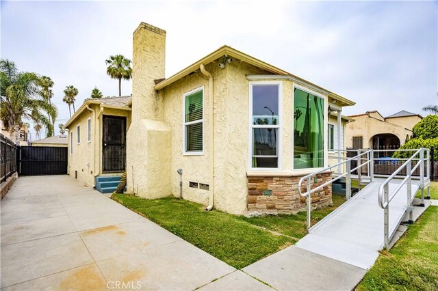 4519 9th Ave, Los Angeles, CA 90043 - view of front of property featuring a chimney, stucco siding, and entry steps