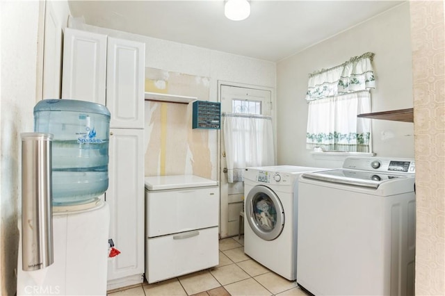 4519 9th Ave, Los Angeles, CA 90043 - laundry room featuring separate washer and dryer, light tile patterned floors, and cabinet space