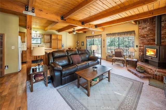 2229 Birchwood Way, Pine Mountain Club, CA 93222 - living area with a wood ceiling with exposed beams, a wood stove, a heating unit, a ceiling fan, and wood finished floors