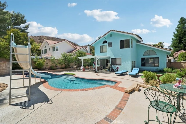 22024 Jeffers Ln, Saugus, CA 91350 - view of pool with a water slide, a pergola, a patio area, and a fenced backyard