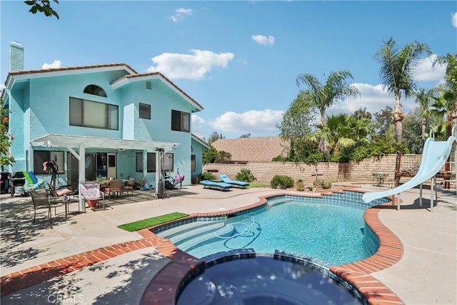 22024 Jeffers Ln, Saugus, CA 91350 - view of swimming pool with a water slide, a pool with connected hot tub, a fenced backyard, and a patio area