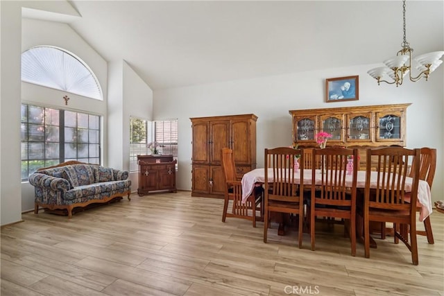 22024 Jeffers Ln, Saugus, CA 91350 - dining space featuring light wood-style floors, plenty of natural light, a chandelier, and high vaulted ceiling