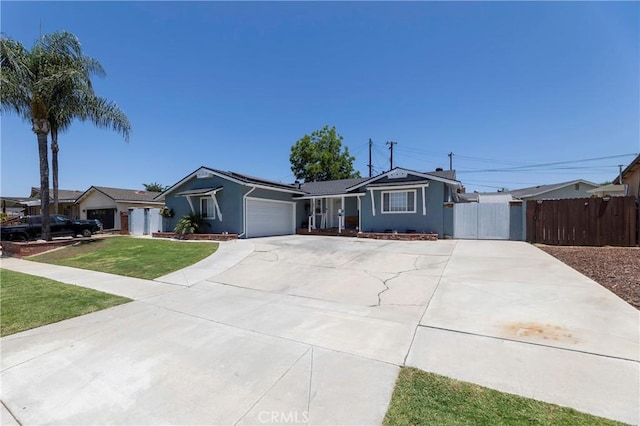 14913 San Ardo Dr, La Mirada, CA 90638 - single story home with an attached garage, concrete driveway, a gate, solar panels, and stucco siding