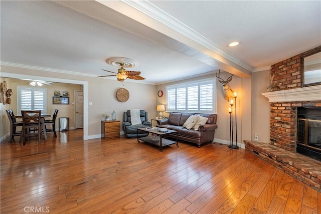 14913 San Ardo Dr, La Mirada, CA 90638 - living room featuring a ceiling fan, crown molding, light wood finished floors, healthy amount of natural light, and a fireplace