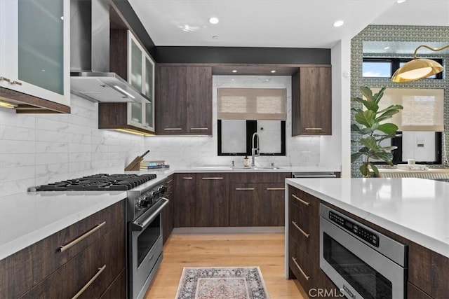 802 Bard St, Hermosa Beach, CA 90254 - kitchen with wall chimney exhaust hood, appliances with stainless steel finishes, light countertops, dark brown cabinetry, and recessed lighting