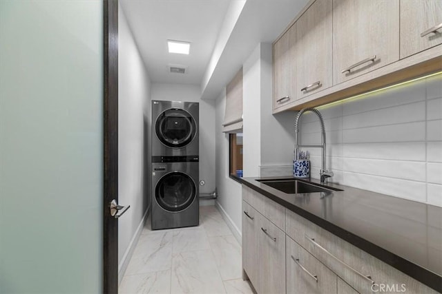 802 Bard St, Hermosa Beach, CA 90254 - washroom featuring stacked washer and clothes dryer, light marble finish flooring, and cabinet space