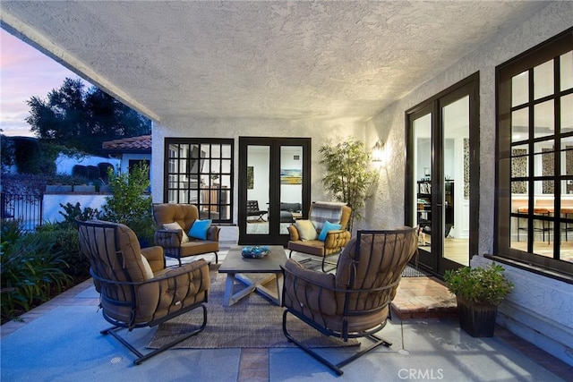29614 Ridgeway Dr, Agoura Hills, CA 91301 - patio terrace at dusk featuring french doors, a patio area, and outdoor lounge area