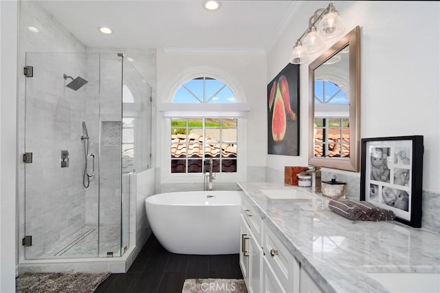 29614 Ridgeway Dr, Agoura Hills, CA 91301 - bathroom featuring double vanity, plenty of natural light, a soaking tub, a stall shower, and crown molding