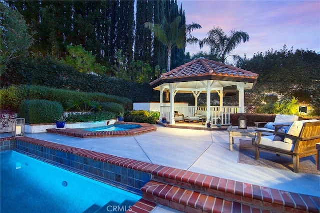 29614 Ridgeway Dr, Agoura Hills, CA 91301 - pool at dusk with a gazebo, an in-ground hot tub, a patio, and outdoor lounge area