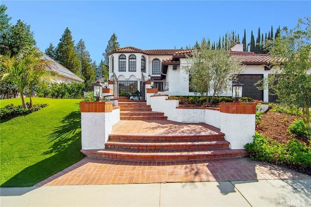 29614 Ridgeway Dr, Agoura Hills, CA 91301 - mediterranean / spanish house featuring stucco siding, a front lawn, and a tile roof