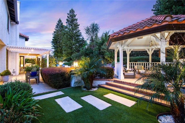 29614 Ridgeway Dr, Agoura Hills, CA 91301 - yard at dusk with a gazebo, a lawn, a pergola, and a patio area