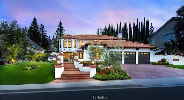 29614 Ridgeway Dr, Agoura Hills, CA 91301 - mediterranean / spanish house with a garage, a chimney, decorative driveway, a tile roof, and a lawn
