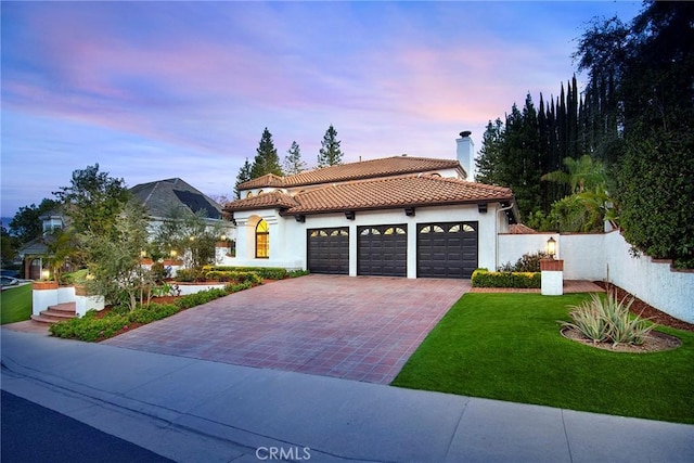 29614 Ridgeway Dr, Agoura Hills, CA 91301 - mediterranean / spanish-style home with a tile roof, decorative driveway, a chimney, and stucco siding