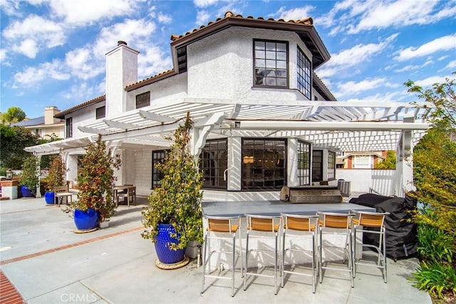 29614 Ridgeway Dr, Agoura Hills, CA 91301 - back of house with a pergola, a patio area, stucco siding, and a tile roof
