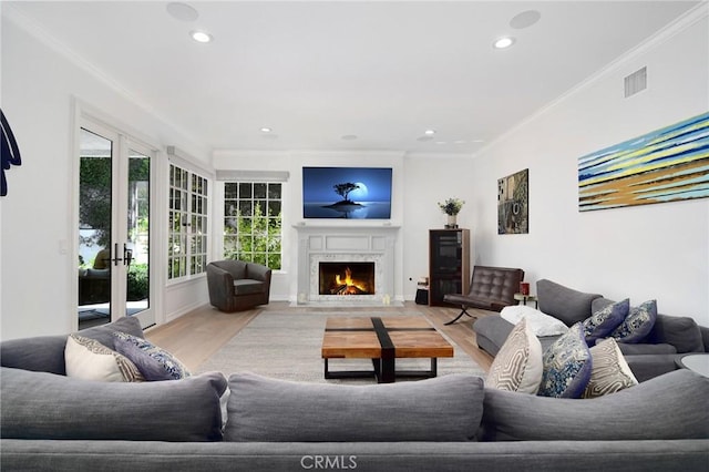 29614 Ridgeway Dr, Agoura Hills, CA 91301 - living area featuring light wood-type flooring, crown molding, french doors, a lit fireplace, and recessed lighting