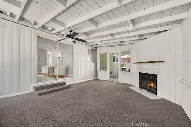 350 E Olive Ave, La Habra, CA 90631 - unfurnished living room with carpet flooring, a high end fireplace, ceiling fan, wood walls, and a wooden ceiling with exposed beams