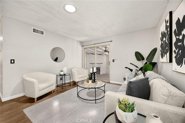 350 E Olive Ave, La Habra, CA 90631 - living room with wood finished floors, a textured ceiling, and ceiling fan