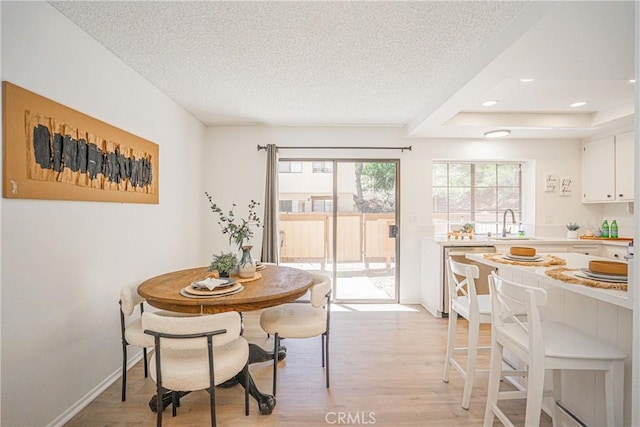 21715 Laurelrim Dr Unit D, Diamond Bar, CA 91765 - dining space with light wood-style floors, a textured ceiling, a raised ceiling, and recessed lighting