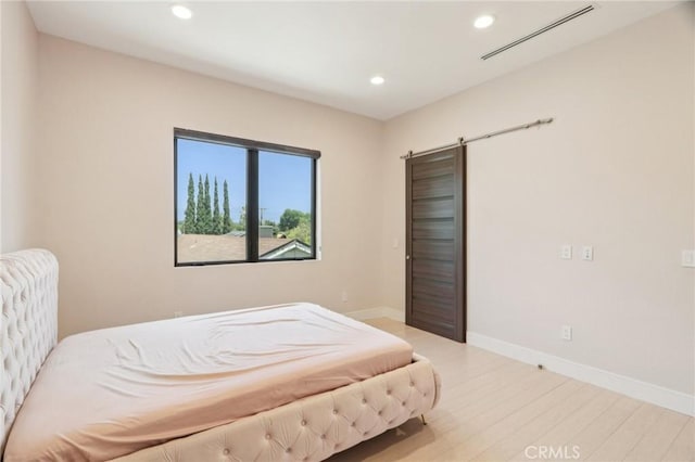 10418 Rubio Ave, Granada Hills, CA 91344 - bedroom featuring wood finished floors, recessed lighting, and a barn door