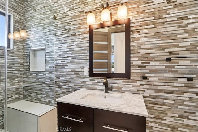 10418 Rubio Ave, Granada Hills, CA 91344 - bathroom with vanity, decorative backsplash, and tiled shower