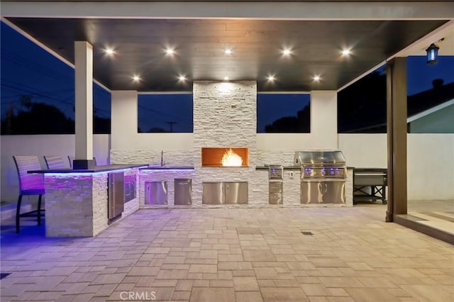 10418 Rubio Ave, Granada Hills, CA 91344 - patio at night featuring area for grilling, wine cooler, and a patio