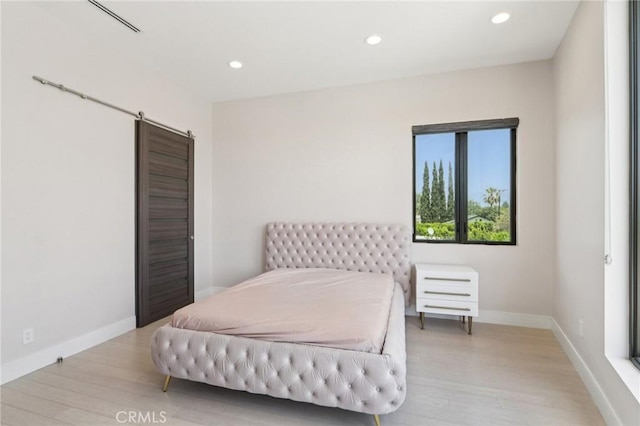 10418 Rubio Ave, Granada Hills, CA 91344 - bedroom featuring wood finished floors, recessed lighting, and a barn door