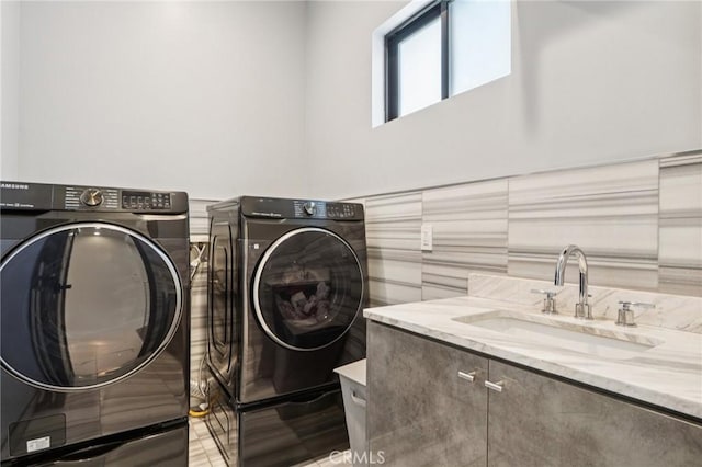 10418 Rubio Ave, Granada Hills, CA 91344 - laundry room featuring washer and clothes dryer, tile walls, and a wainscoted wall