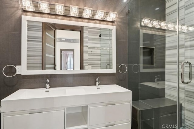 10418 Rubio Ave, Granada Hills, CA 91344 - full bathroom featuring double vanity, a shower stall, and tile walls