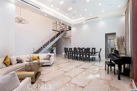 10418 Rubio Ave, Granada Hills, CA 91344 - living room featuring a high ceiling, stairs, marble tiled floors, recessed lighting, and a chandelier