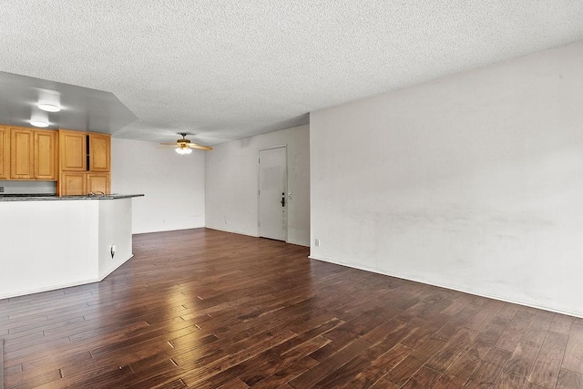 3611 S Bear St Unit K, Santa Ana, CA 92704 - unfurnished living room featuring a ceiling fan, dark wood-style flooring, and a textured ceiling