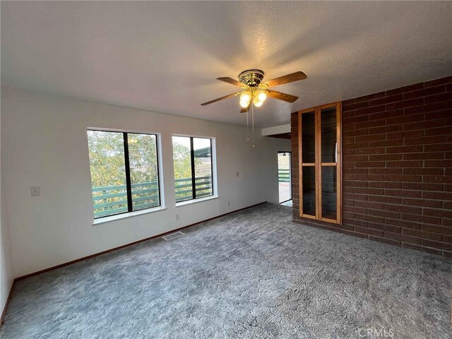 28714 Cruthers Creek Rd, Pearblossom, CA 93553 - unfurnished living room with carpet, ceiling fan, and a textured ceiling